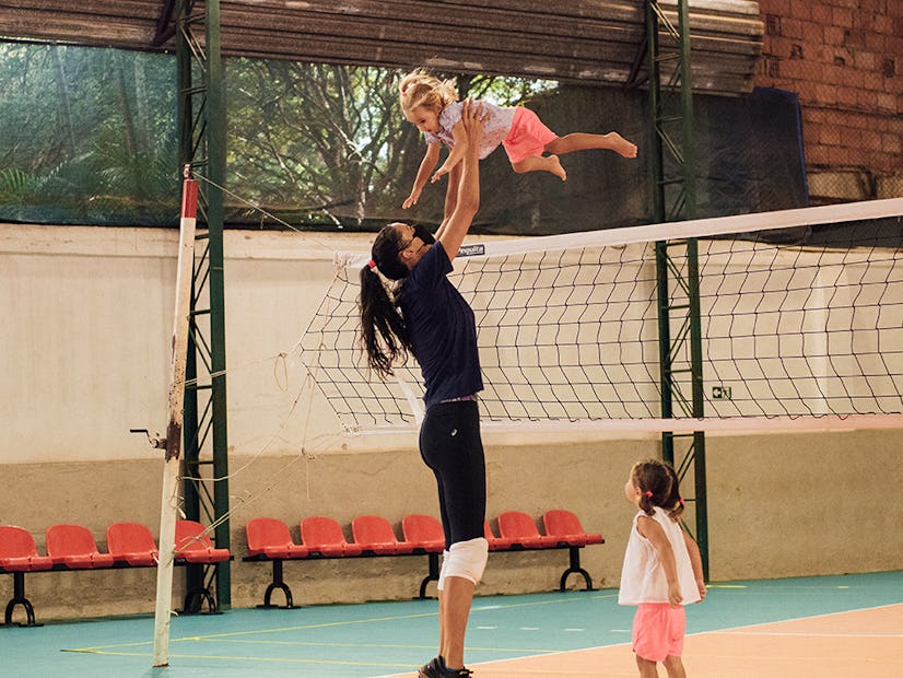 Sheilla with her daughters on the volleyball court.