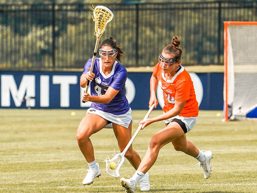 Athletes Unlimited Lacrosse players go for ball.