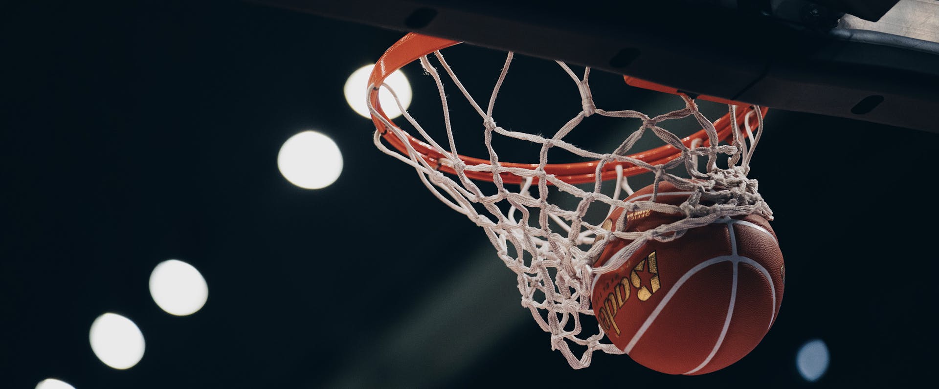 Basketball falling through net