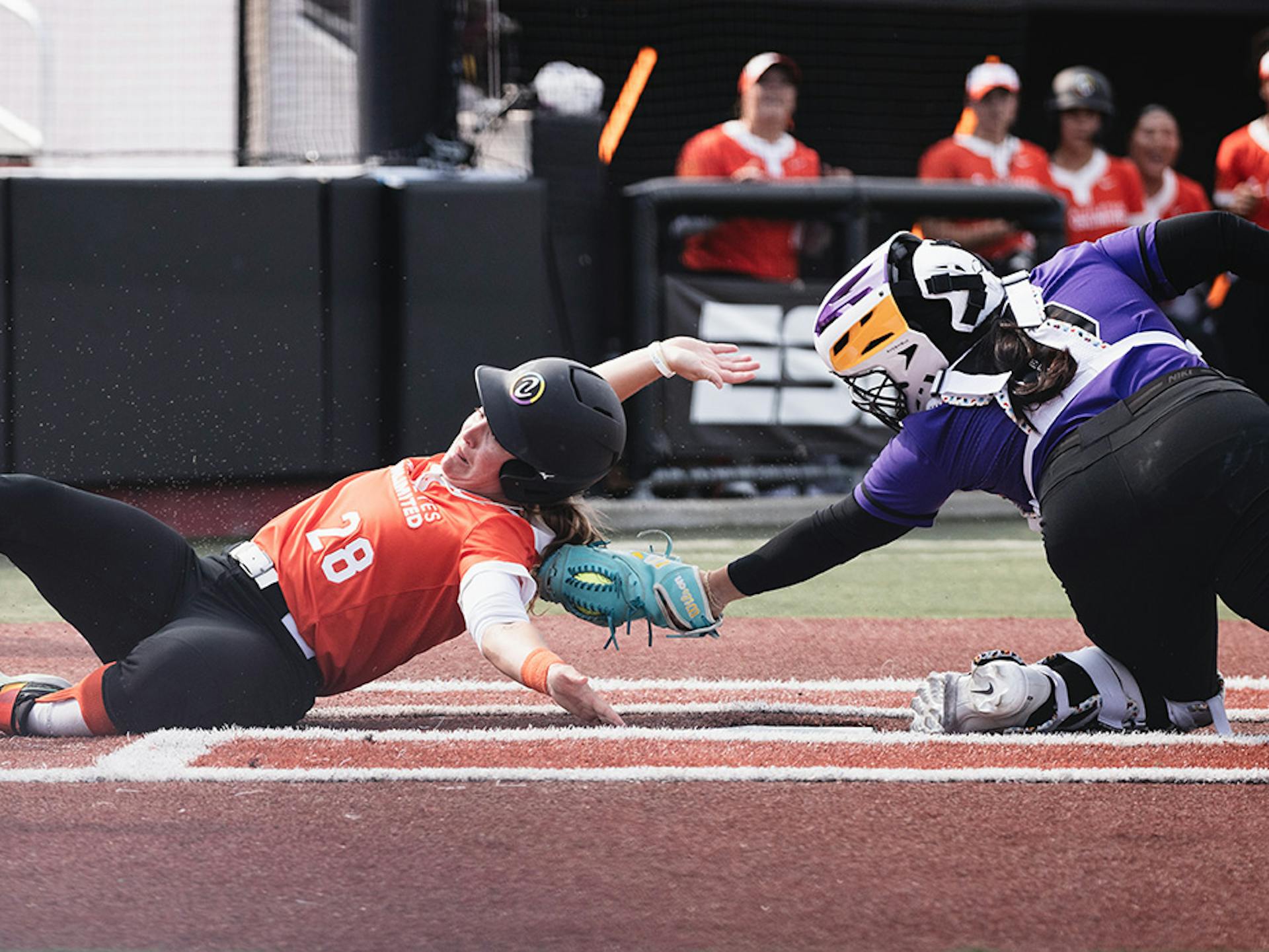 Haylie McCleney slides into home as Sashel Palacios swipes to tag her