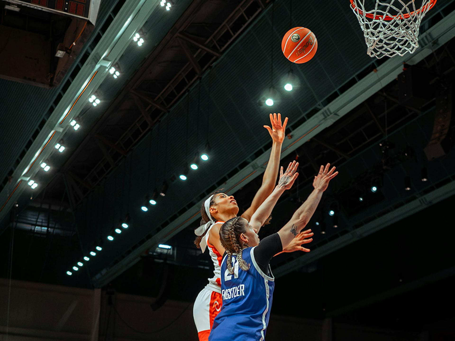 Isabelle Harrison and Emily Engstler jump for the rebound.