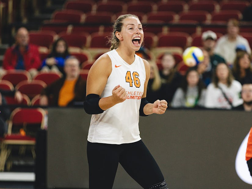 Morgan Hentz in a white and orange jersey celebrates a point during an AU Pro Volleyball Championship match
